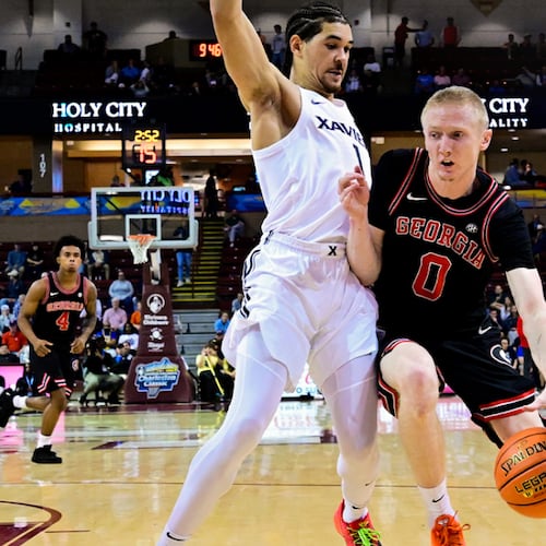 Georgia’s Blue Cain (right) drives on Xavier during the Bulldogs 78-77 win on Friday, Nov. 21, 2025, in Cincinnati. Cain led UGA with 16 points Friday night. (@GeorgiaBasketball on X)