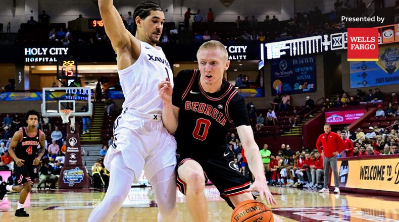 Georgia’s Blue Cain (right) drives on Xavier during the Bulldogs 78-77 win on Friday, Nov. 21, 2025, in Cincinnati. Cain led UGA with 16 points Friday night. (@GeorgiaBasketball on X)