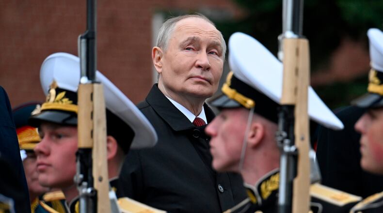 Russian President Vladimir Putin, centre foreground, attends a ceremony to lay flowers at the Tomb of the Unknown Soldier by the Kremlin wall inMoscow, Saturday, May 9, 2026, during celebrations of the 81st anniversary of the Soviet Union's victory over Nazi Germany during the World War II. (Alexander Nemenov/Pool Photo via AP)