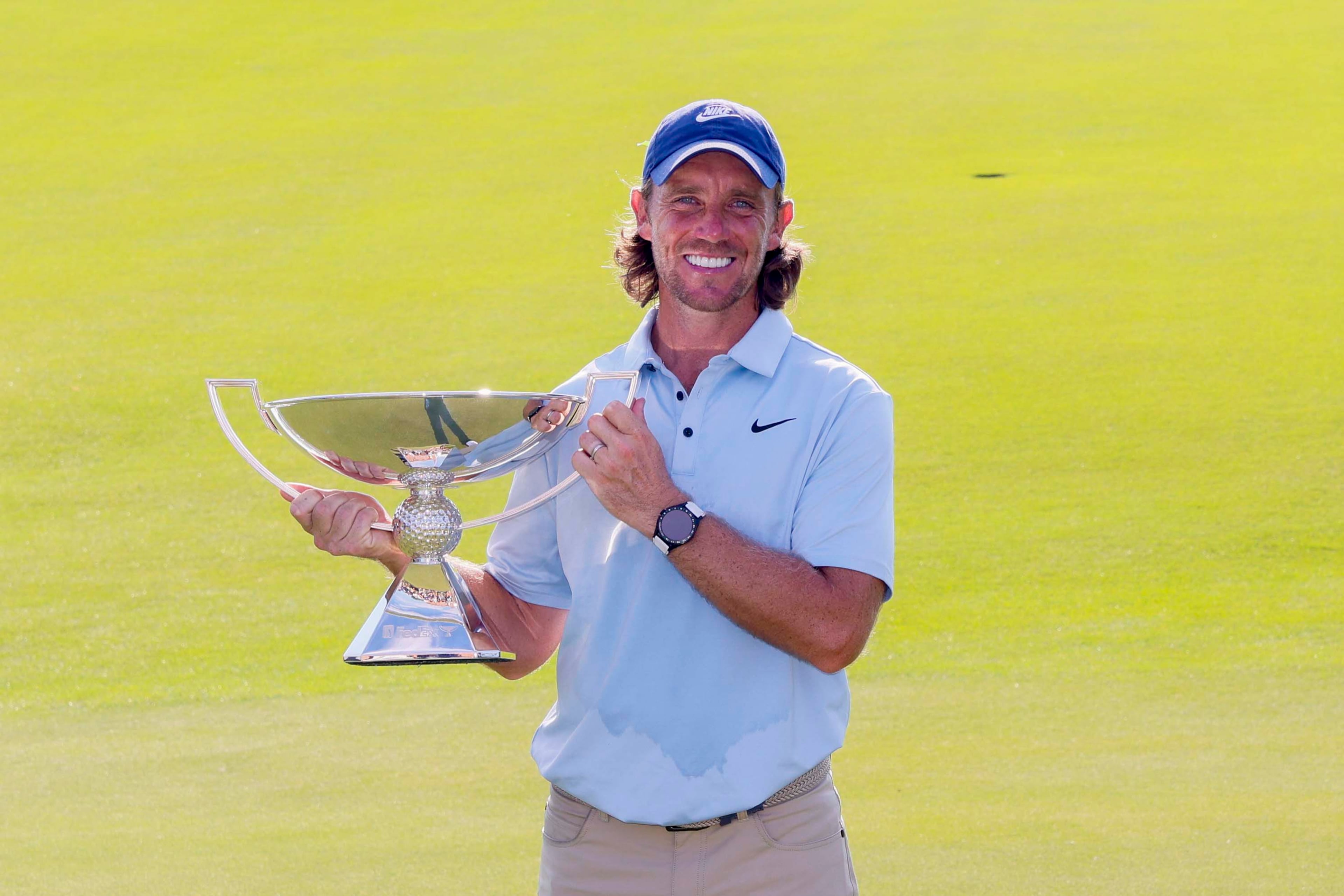 Tommy Fleetwood, from England, poses for the media as he holds the PGA Tour Championship trophy at East Lake Golf Club on Sunday, Aug. 24, 2025, in Atlanta. (Miguel Martinez/ AJC)