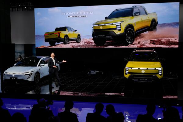 An executive from Nissan unveiled the Frontier Pro, a plug-in hybrid, during the Shanghai auto show on Wednesday, April 23, 2025. (AP Photo/Ng Han Guan)