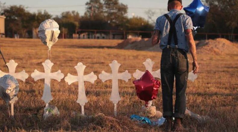 Derrick Bernaden of San Antonio, Texas visits a memorial where 26 crosses stand in a field on the edge of town to honor the 26 victims killed at the First Baptist Church of Sutherland Springs. (Getty Images)