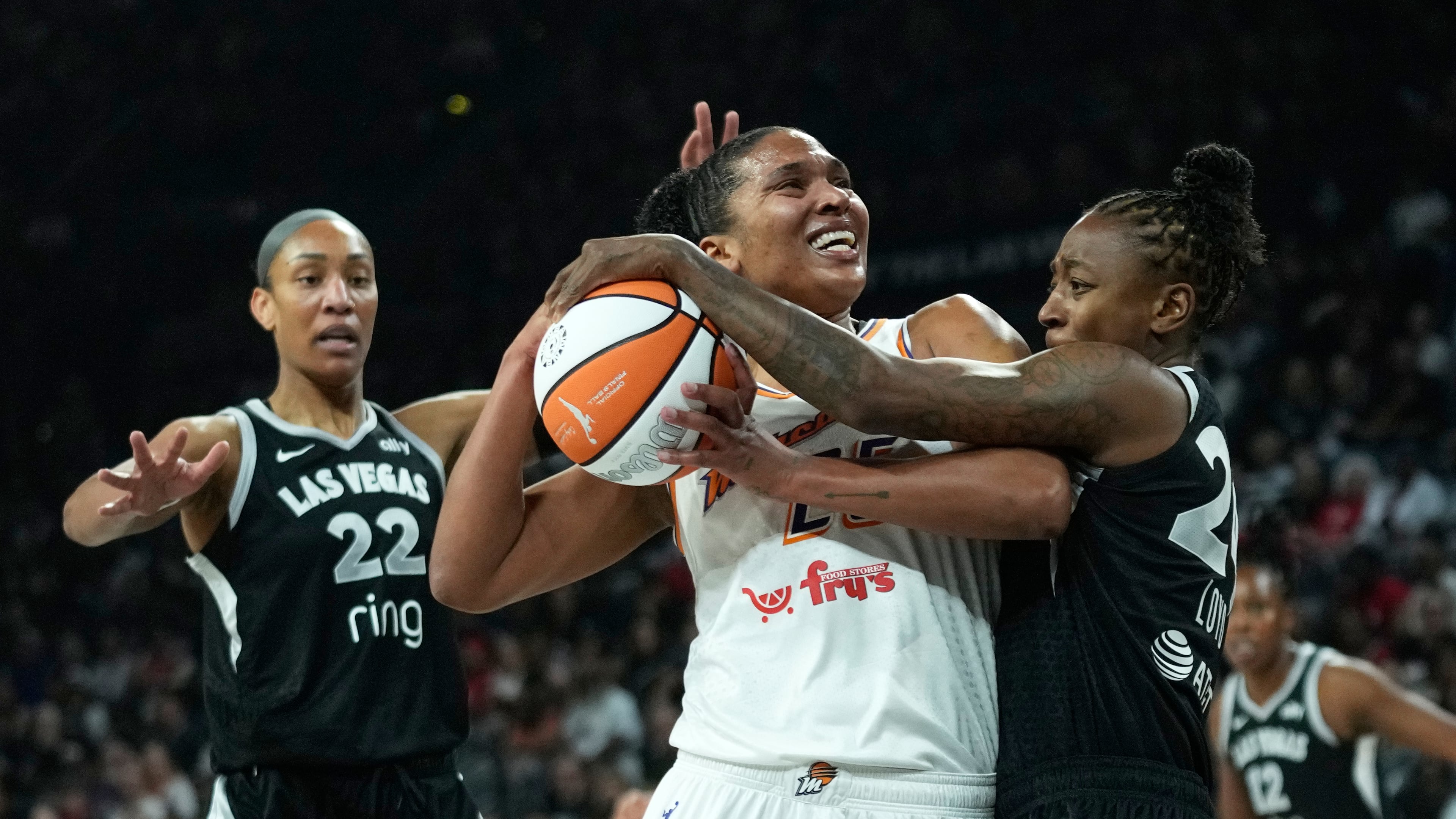 Las Vegas Aces guard Jewell Loyd (24), right, fouls Phoenix Mercury forward Alyssa Thomas (25) during the first half in Game 2 of the WNBA basketball finals, Sunday, Oct. 5, 2025, in Las Vegas. (AP Photo/John Locher)