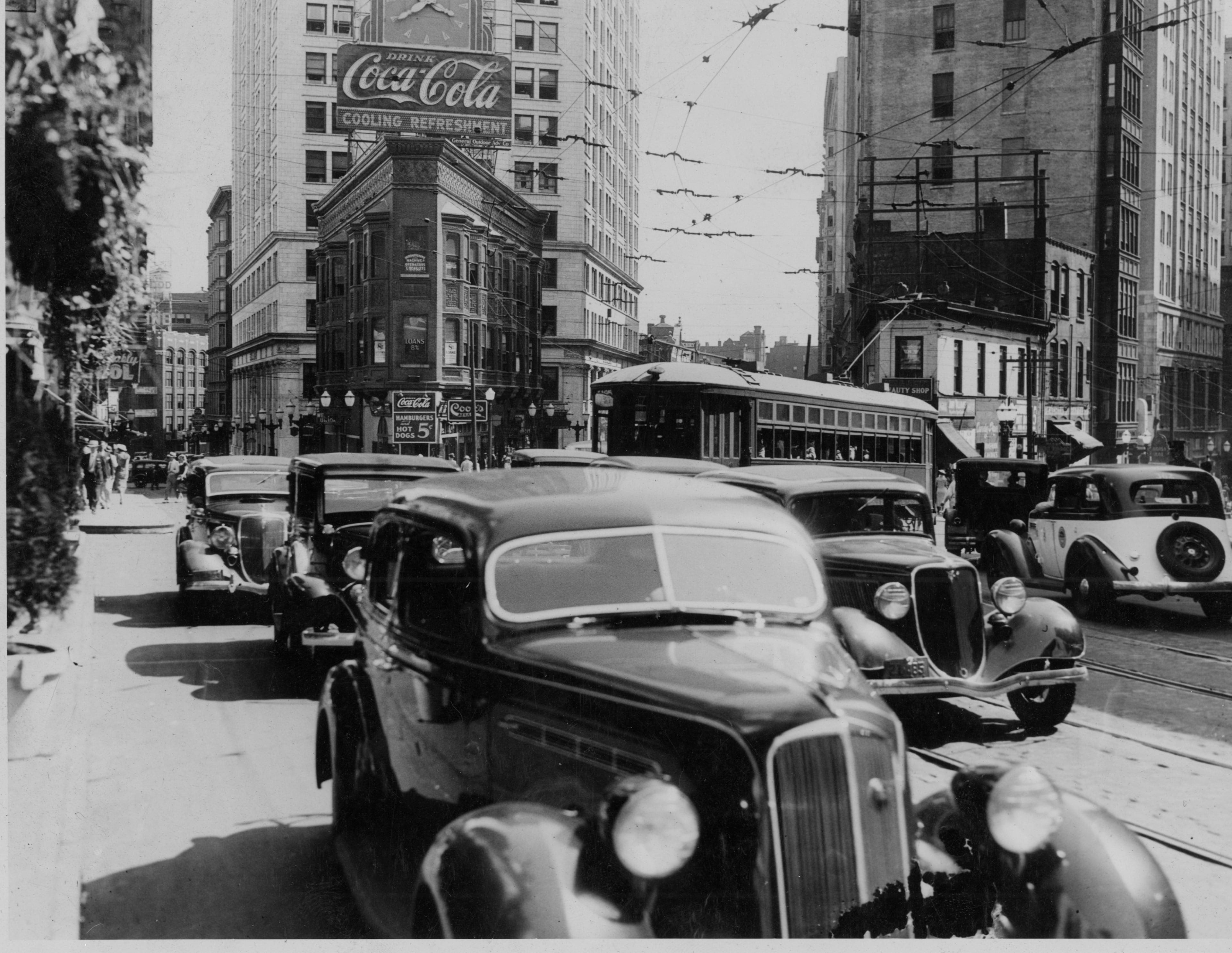 Cars and and a streetcar navigate traffic on Peachtree Street near the intersection with Pryor Street (left) and Forsyth Street (right). The Atlanta Journal-Constitution/AJC Staff.