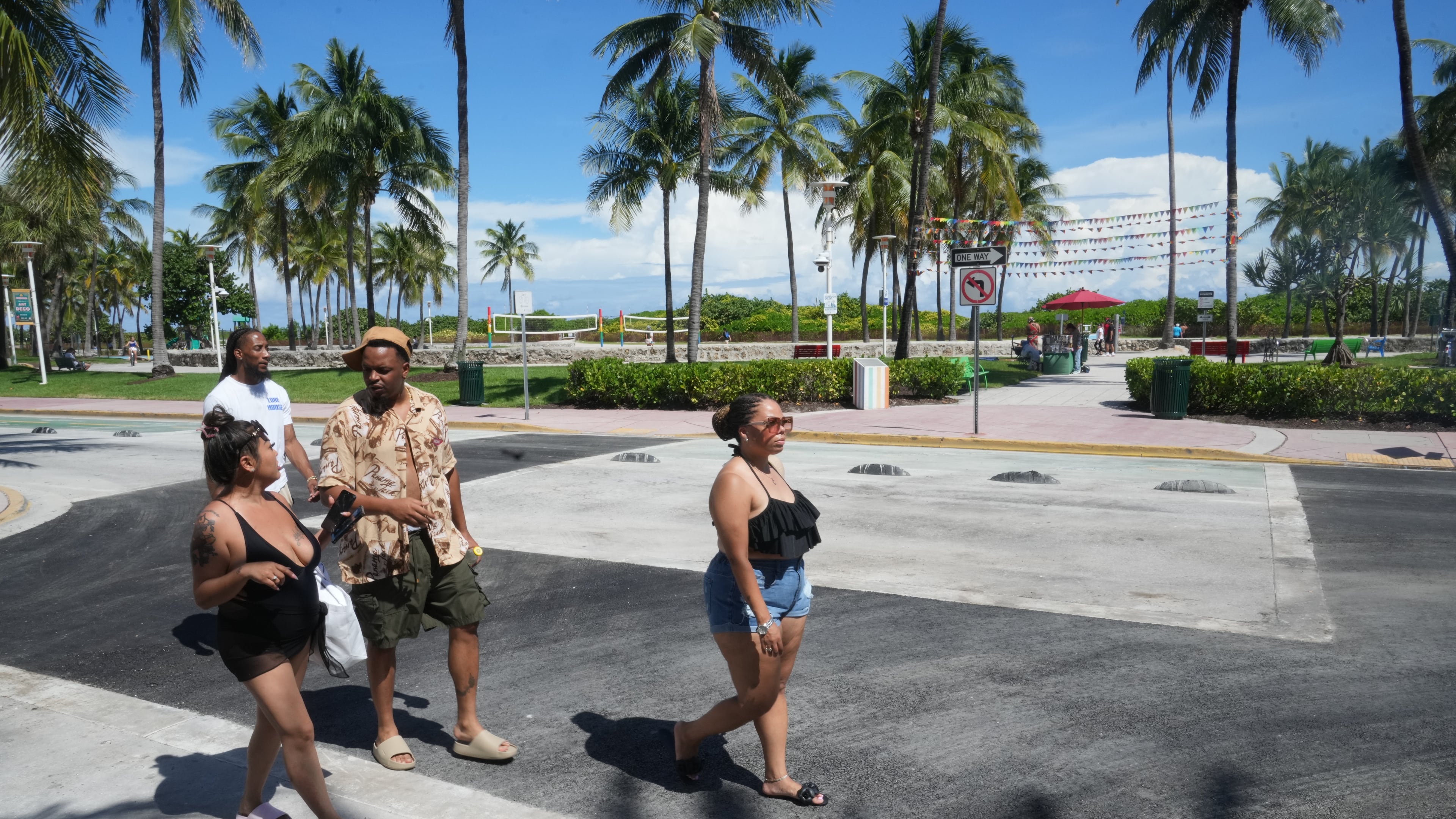 Pedestrians walk over a crosswalk on Miami Beach's iconic Ocean Drive that used to be rainbow-colored celebrating the history and contributions of the LGBTQ+ community, Monday, Oct. 6, 2025. (AP Photo/Marta Lavandier)
