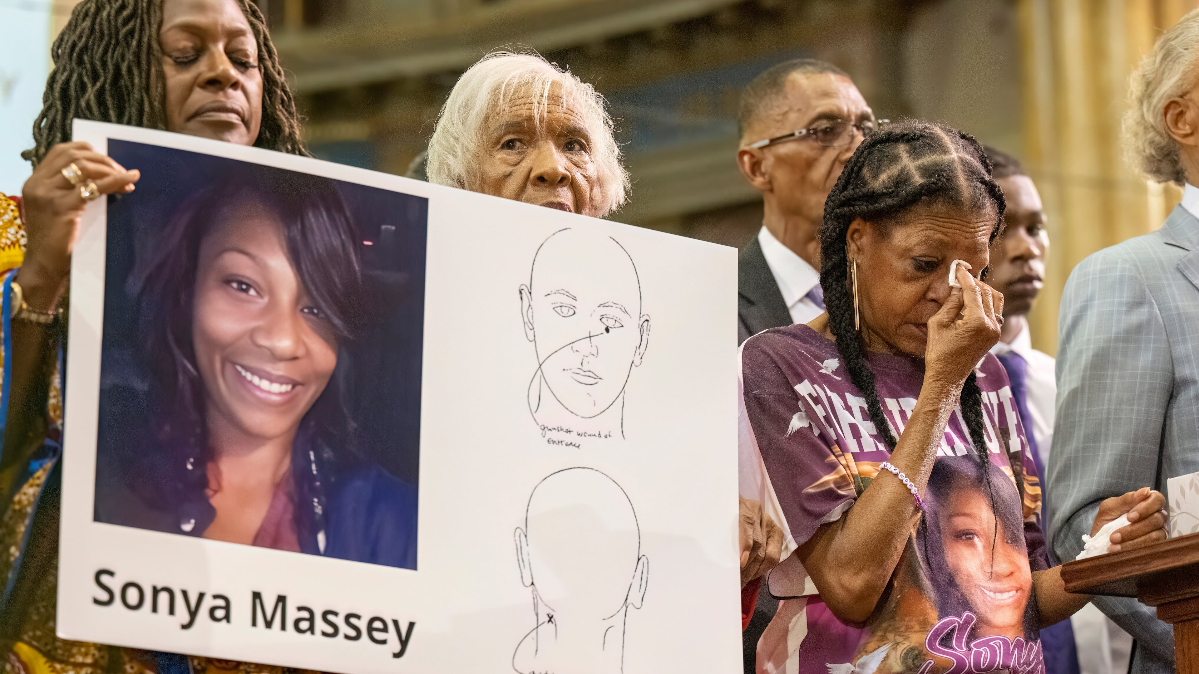 FILE - Donna Massey, center right, wipes tears from her face as she listens to Rev. Al Sharpton, right, speak during a press conference over the shooting death of her daughter Sonya, who was killed by Illinois sheriff's deputy Sean Grayson, at New Mount Pilgrim Church in the Garfield Park neighborhood in Chicago, Tuesday, July 30, 2024. (Tyler Pasciak LaRiviere/Chicago Sun-Times via AP, file)