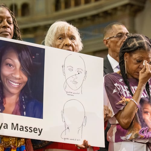 FILE - Donna Massey, center right, wipes tears from her face as she listens to Rev. Al Sharpton, right, speak during a press conference over the shooting death of her daughter Sonya, who was killed by Illinois sheriff's deputy Sean Grayson, at New Mount Pilgrim Church in the Garfield Park neighborhood in Chicago, Tuesday, July 30, 2024. (Tyler Pasciak LaRiviere/Chicago Sun-Times via AP, file)
