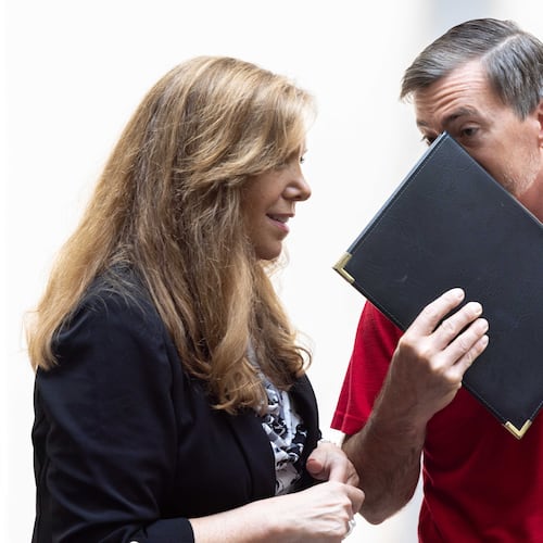 Republican Jason Frazier (right) speaks with a supporter after the public comment portion of the Fulton County Board of Commissioners meeting in Atlanta on Wednesday, June 7, 2023. The board was voting on whether to make Frazier, who has challenged the registrations of 10,000 voters, a member of the county elections board. (Arvin Temkar/AJC)