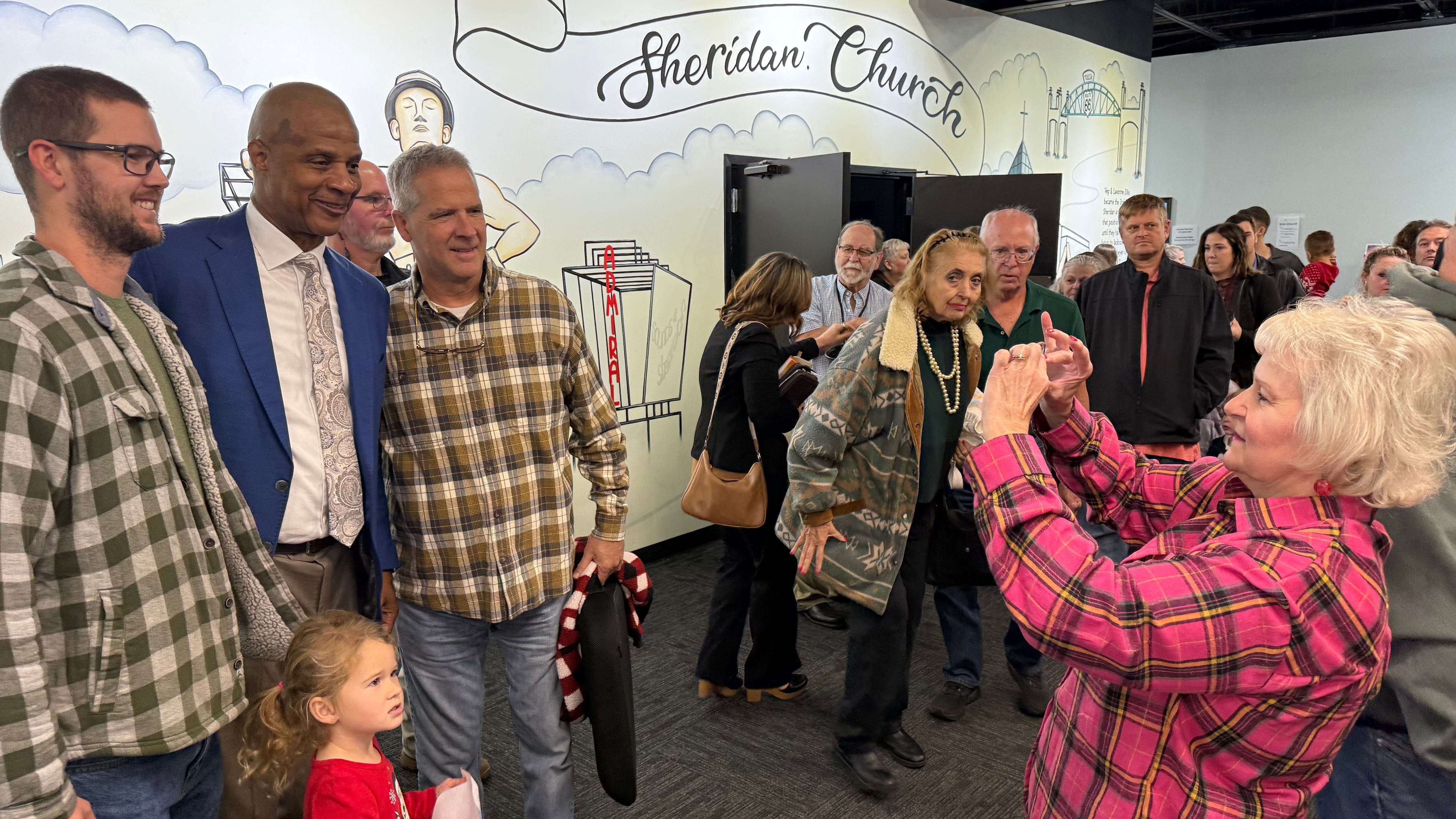 Former Major League baseball player Darryl Strawberry, second from left, poses with some of the people who heard him preach on Sunday, Nov. 23, 2025, at Sheridan Church, in Tulsa, Okla. (AP Photo/Bobby Ross)