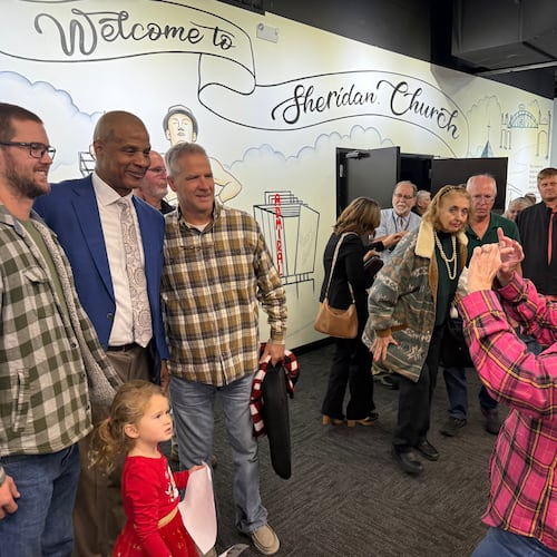 Former Major League baseball player Darryl Strawberry, second from left, poses with some of the people who heard him preach on Sunday, Nov. 23, 2025, at Sheridan Church, in Tulsa, Okla. (AP Photo/Bobby Ross)