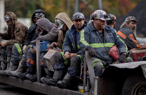FILE - In this Oct. 15, 2014 photo, coal miners return on a buggy after working a shift underground at the Perkins Branch Coal Mine in Cumberland, Ky. (AP Photo/David Goldman, File)