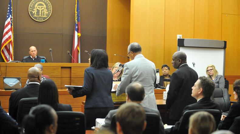 APRIL 14, 2015 ATLANTA Former APS Usher Collier Heights Elem testing coordinator Donald Bullock (right) stands as his defense attorney Hurl Taylor accepts a sentencing deal for 5 years probation, 6 months of weekends in jail, $5000 fine and 1500 hours of community service. Sentencing continues for 10 of the 11 defendants convicted of racketeering and other charges in the Atlanta Public Schools test-cheating trial before Judge Jerry Baxter in Fulton County Superior Court, Tuesday, April 14, 2015. (Atlanta Journal-Constitution, Kent D. Johnson, Pool)