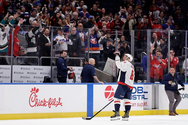 Washington Capitals left wing Alex Ovechkin (8) waves to spectators as he leaves the ice after an NHL hockey game against New York Islanders in Elmont, N.Y., Sunday, April 6, 2025. (AP Photo/Adam Hunger)