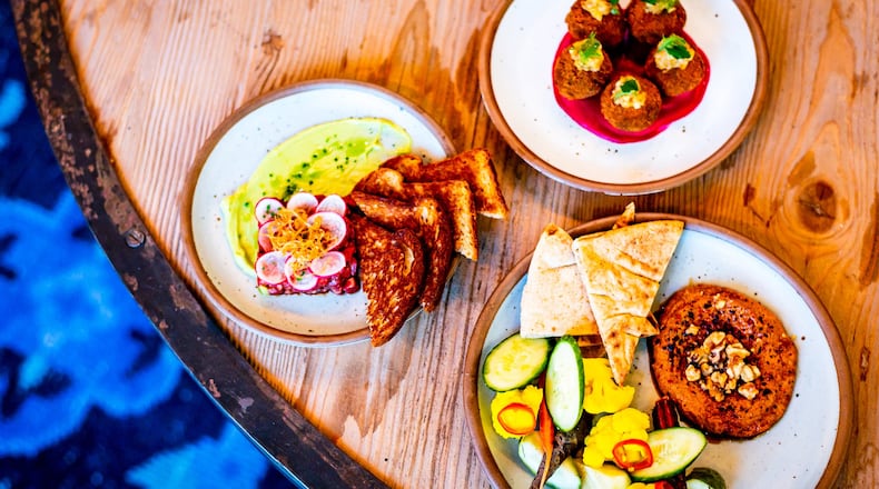 Appetizers at the Bold Monk, including (clockwise from top): Bitterballen, mezze and steak tartare. CONTRIBUTED BY HENRI HOLLIS