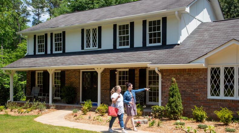 Real Estate agent Maura Neill, right, looks over a Roswell house for sale with homebuyer Anna Devlin on Friday, April 29, 2022.