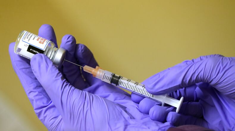 RN Courtney Kirkland prepares a Moderna COVID-19 vaccination at the Paulding County Health Department. (Curtis Compton / Atlanta Journal-Constitution)