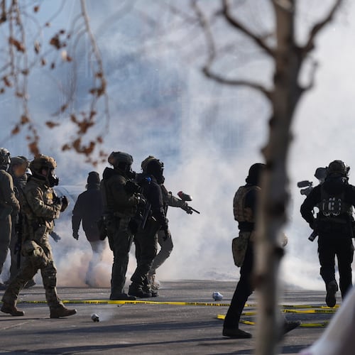 FILE - Federal immigration officers deploy tear gas at protesters after a shooting Jan. 24, 2026, in Minneapolis. (AP Photo/Abbie Parr, File)