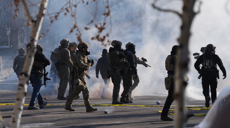 FILE - Federal immigration officers deploy tear gas at protesters after a shooting Jan. 24, 2026, in Minneapolis. (AP Photo/Abbie Parr, File)