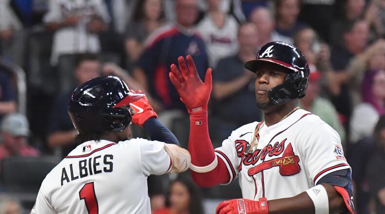 September 30, 2021 Atlanta - Atlanta Braves right fielder Jorge Soler (12) celebrates with Atlanta Braves second baseman Ozzie Albies (1) after hiting a solo home run in the first inning at Truist Park on Thursday, September 30, 2021. (Hyosub Shin / Hyosub.Shin@ajc.com)