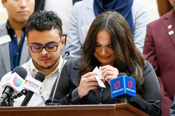 Spanish-language journalist Mario Guevara's daughter, Katherine Guevara, reacts as she struggles to find words during a press conference at the Georgia State Capitol in Atlanta, on Tuesday, July 22, 2025. (Miguel Martinez/Atlanta Journal-Constitution via AP)