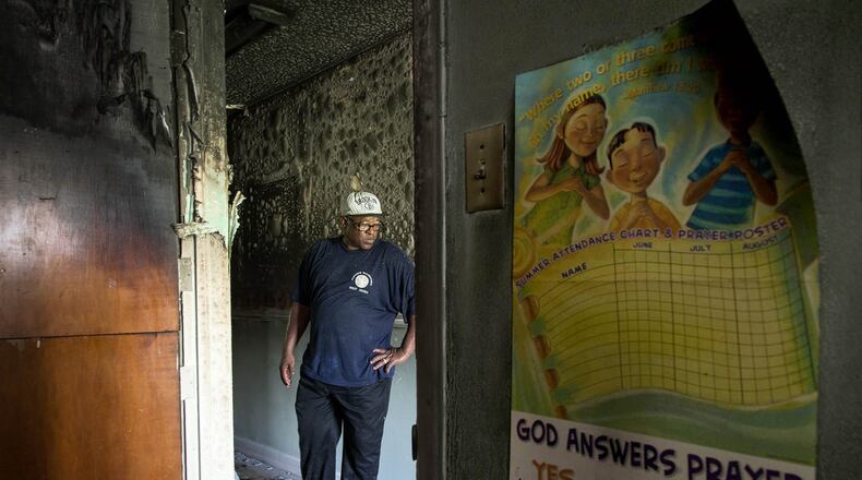 Sergio Fuentes, minister at Westgate New Testament Church looks at damage done by a fire set at the church at 1200 Tallahassee Drive in West Palm Beach, Florida on August 12, 2016. A man accused of setting the fire is being held without bond and will have a psychiatric examination done. (Allen Eyestone / The Palm Beach Post)