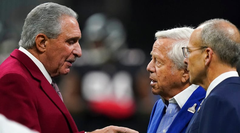 Atlanta Falcons owner Arthur Blank, left, speaks with New England Patriots owner Robert Kraft, second from right, before a game in Atlanta. Blank, a member of the NFL’s Diversity, Equity and Inclusion committee, believes the league has dropped the ball by not hiring more Black head coaches. (AP Photo/Brynn Anderson)