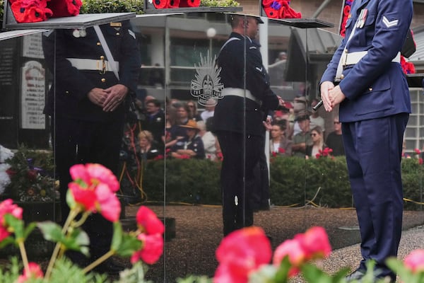 Officers in the honor guard are reflected in the cenotaph during the Anzac Day commemorations in Nelson Bay, Australia, Friday, April 25, 2025. (AP Photo/Mark Baker)