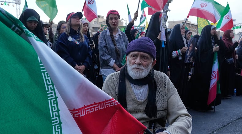 A man holds an Iranian flag in a state-organised rally in Tehran, Iran, Wednesday, April 29, 2026, celebrating the birthday of Imam Reza, the 8th Shiite Muslims' Imam, and supporting Iranian Supreme Leader Ayatollah Mojtaba Khamenei. (AP Photo/Vahid Salemi)