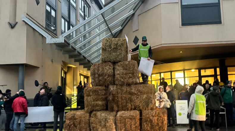 Haystacks pile up outside a court house as French oil giant TotalEnergies is on trial, accused by Belgian farmer Hugues Falys and three environmental groups of bearing responsibility for climate change, Wednesday, Nov. 19, 2025 in Tournai, Belgium. (AP Photo/Sylvain Plazy)
