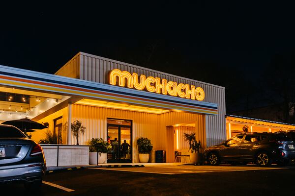 The exterior of Muchacho glowing at night