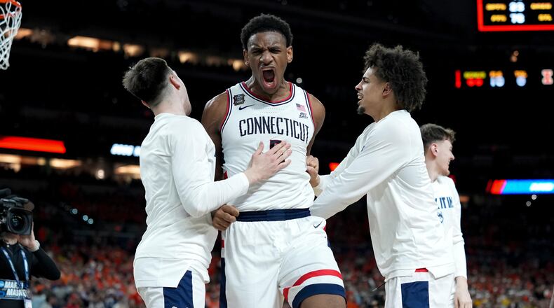 UConn forward Tarris Reed Jr., center, celebrates after the second half of an NCAA college basketball tournament semifinal game against Illinois at the Final Four, Saturday, April 4, 2026, in Indianapolis. (AP Photo/Abbie Parr)