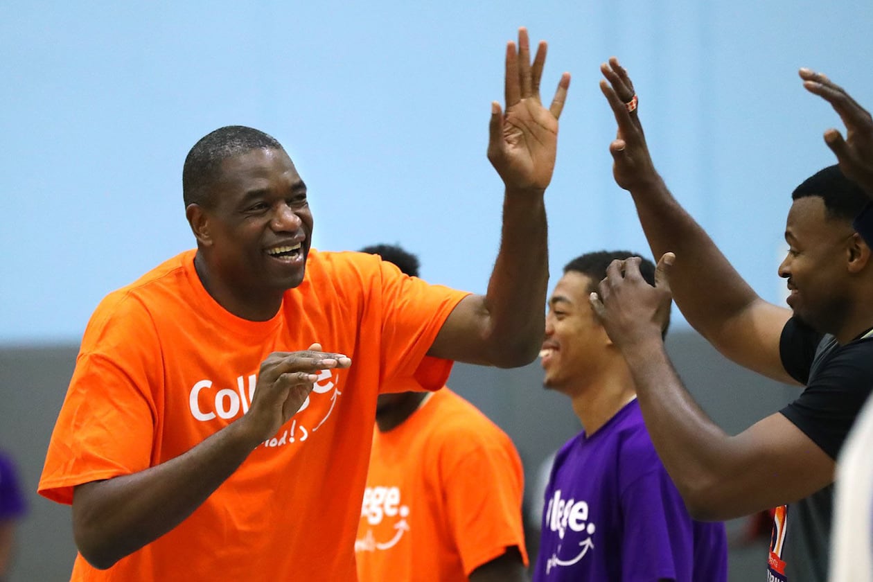 Dikembe high fives his teammates at the Breakthrough Atlanta Celebrity Basketball Game at the Lovett School in May 2017.