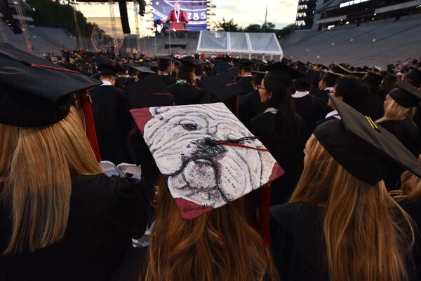 Students wear decorated mortarboards during the 2018 spring undergraduate commencement ceremony at Sanford Stadium in Athens on Friday, May 4, 2018. HYOSUB SHIN / HSHIN@AJC.COM