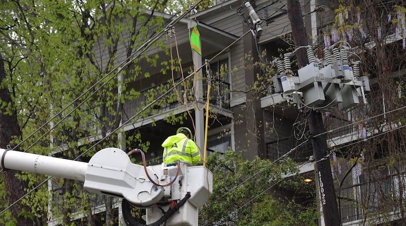 A Georgia Power crew repairs storm damage in Roswell in this April file photo. HYOSUB SHIN / HSHIN@AJC.COM