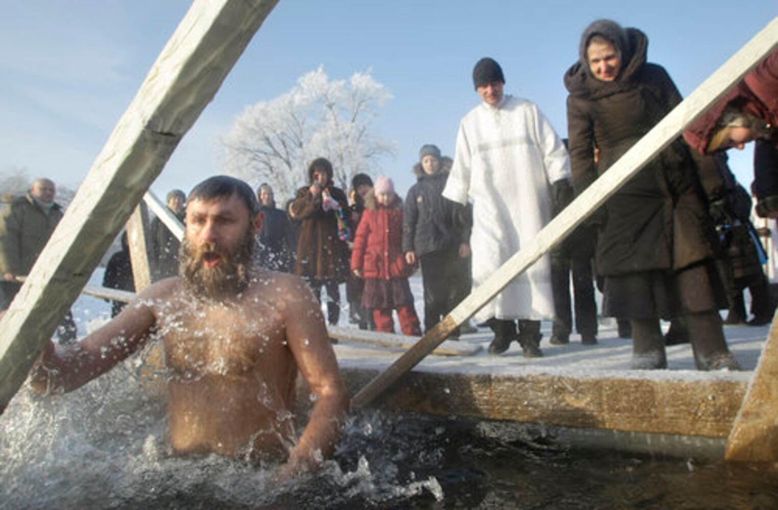 Think it's cold? Russians plunge into ice bath