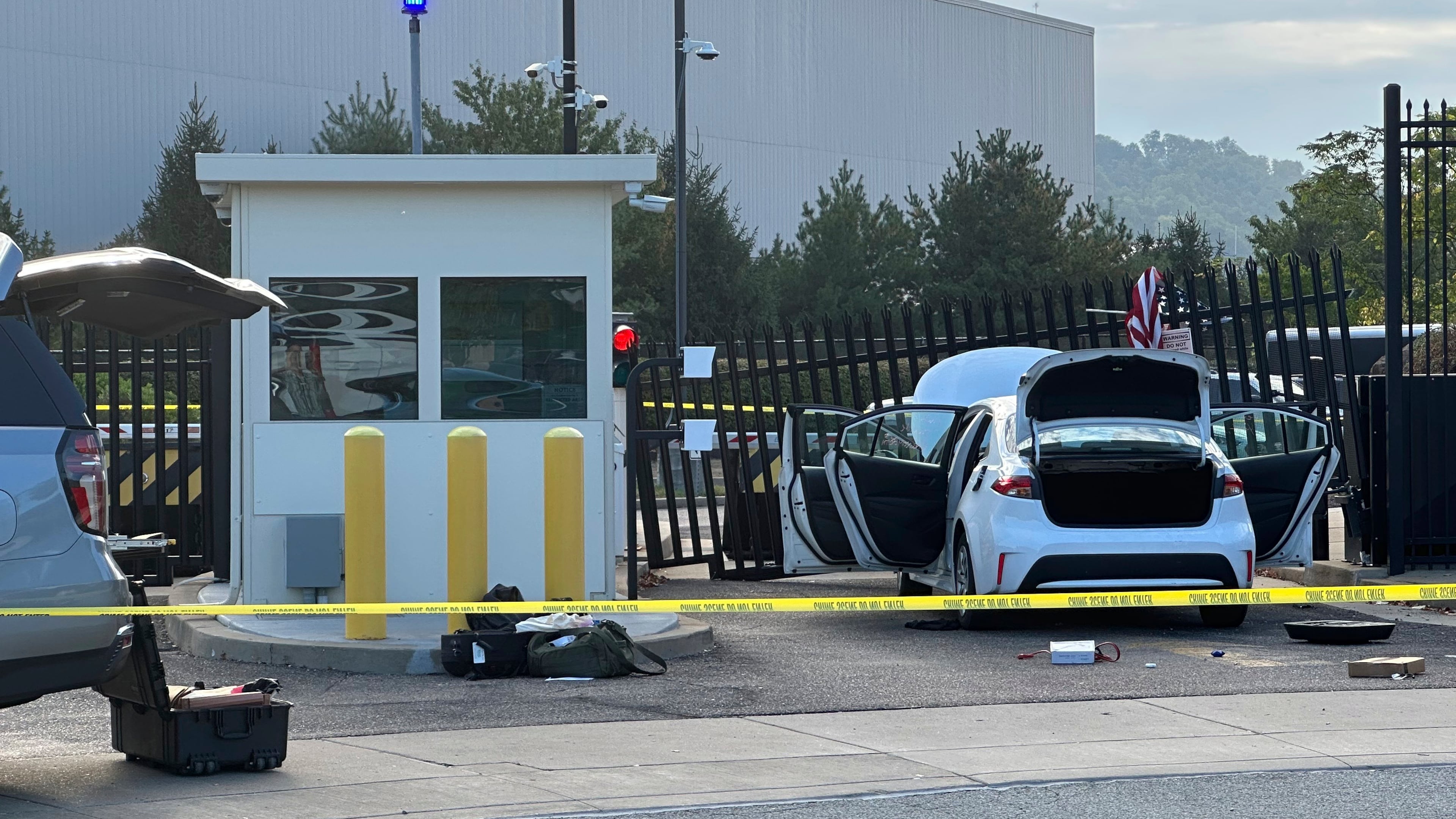 FBI officials inspect a car that rammed into a gate at the FBI building in Pittsburgh, Wednesday, Sept. 17, 2025. (AP Photo/Peter Smith)