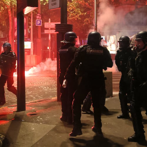 Police try to disperses PSG supporters who left off fireworks as they celebrate in Paris, Saturday, May 30, 2026 after the Champions League final soccer match between Paris Saint-Germain and Arsenal that was played in Budapest, PSG won the game. (AP Photo/Thomas Padilla)