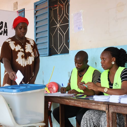 A voter casts her ballot during a referendum on granting new presidential powers, in Bissau, Guinea Bissau, Sunday, Aug. 30, 2026. (AP Photo/Darcicio Barbosa)
