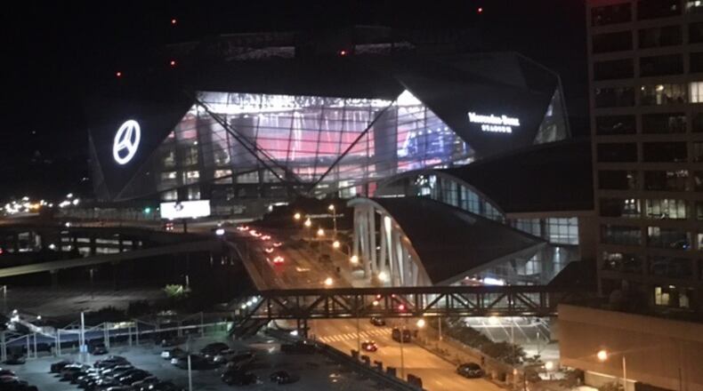 Mercedes-Benz Stadium lights up the skyline at night. (By D. Orlando Ledbetter)