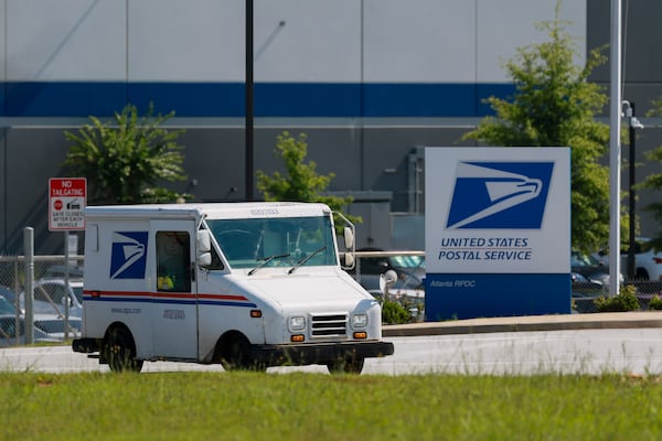 A U.S. Postal truck leaves the Atlanta Regional Processing and Distribution Center, Thursday, July 9, 2026, in Atlanta. The APWU demands answers on the Postal Service’s emergency preparedness following the death of four U.S. Postal workers. (Jason Getz/AJC)