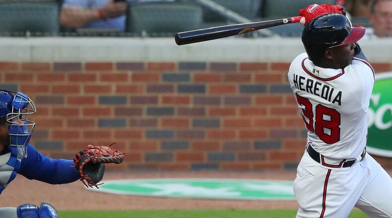 Braves outfielder Guillermo Heredia hits an RBI double to give Atlanta a 4-0 lead in the first inning Monday, April 26, 2021, against the Chicago Cubs at Truist Park in Atlanta. (Curtis Compton / Curtis.Compton@ajc.com)