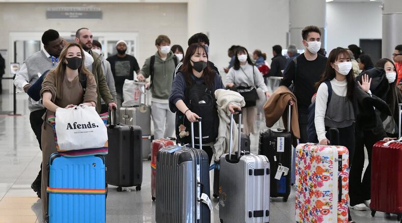 International travelers wearing a mask arrive at Hartsfield-Jackson on Tuesday, March 3, 2020. (Hyosub Shin / Hyosub.Shin@ajc.com)