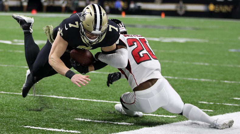 The Saints' Taysom Hill is tackled by the Falcons' Kendall Sheffield Nov. 10, 2019, at the Mercedes Benz Superdome in New Orleans.