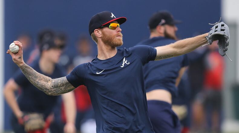 Braves pitcher Mike Foltynewicz loosens up his arm on the first day pitchers and catchers report to begin spring training Wednesday, Feb. 12, 2020, in North Port, Fla.