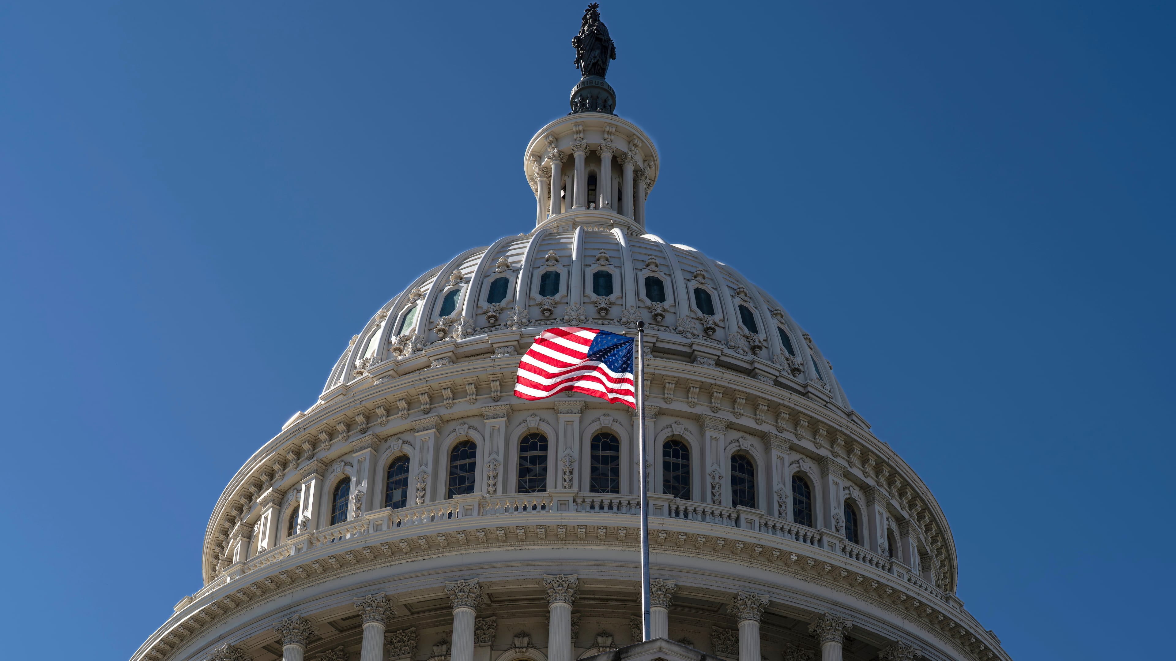 The American flag flies over the Capitol in Washington, on the ninth day of the government shutdown, Thursday, Oct. 9, 2025. (AP Photo/J. Scott Applewhite)