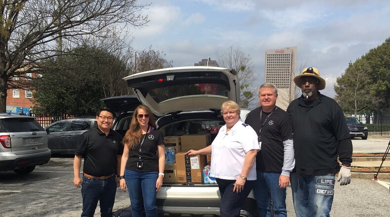 Members from Mercedes-Benz USA and The Salvation Army unload 500 emergency kits at The Salvation Army Metro Atlanta Red Shield Shelter. Pictured (L-R): Benjamin Zhang, Kat Reynolds, Janeane Schmidt, Michael Swearingen, Michael Davidson. Courtesy Mercedes Benz-USA