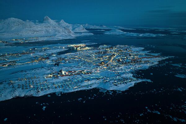Houses covered by snow are seen on the coast of a sea inlet of Nuuk, Greenland, Friday, March 7, 2025. (AP Photo/Evgeniy Maloletka)