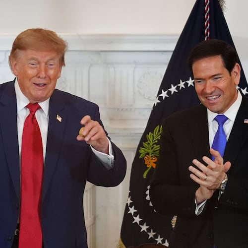 President Donald Trump holds a gold nugget he was presented as Secretary of State Marco Rubio watches during a roundtable on the American mining industry, Friday, Aug. 7, 2026, at the State Department in Washington. (AP Photo/Julia Demaree Nikhinson)