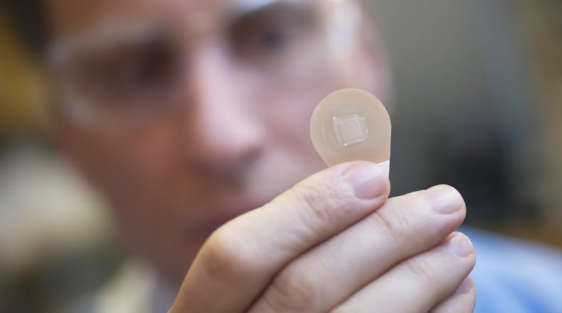 Micron Biomedical co-founder Mark Prausnitz holds a microneedle patch. They could be available in a few years. CONTRIBUTED BY CHRISTOPHER MOORE / GEORGIA TECH