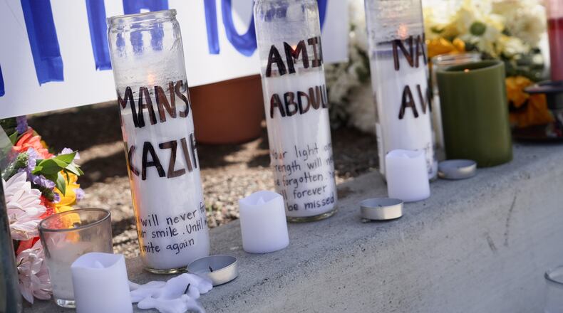Candles with victims names are placed outside the Islamic Center of San Diego in the aftermath of a shooting on Wednesday, May 20, 2026, in San Diego. (AP Photo/Ty Oneil)